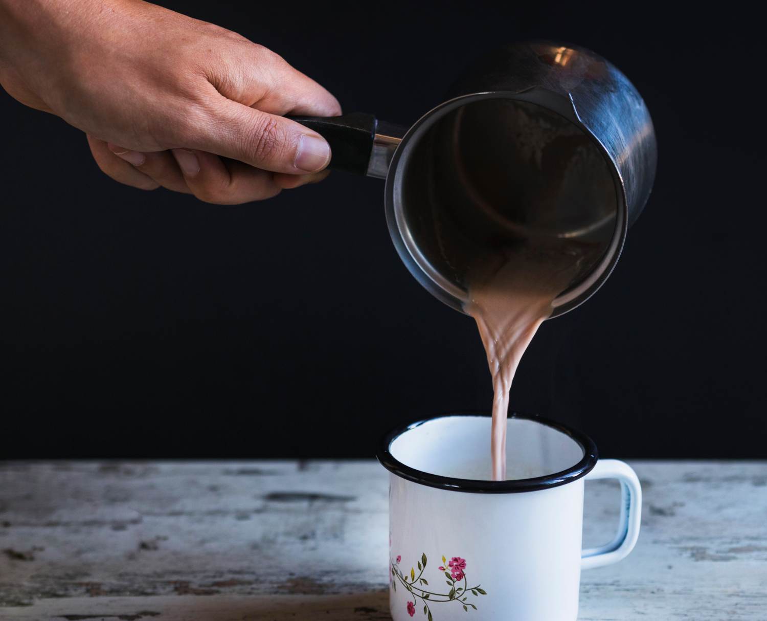 crop-hand-filling-cup-with-hot-chocolate (1)